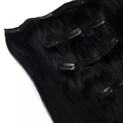 Black hair extensions with clips on a white background